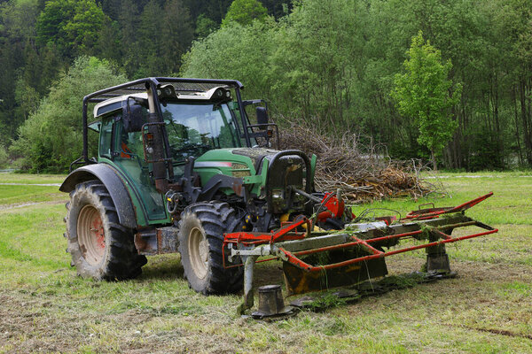 Tractor working on the farm, a modern agricultural transport, a farmer working in the field, modern tractor
