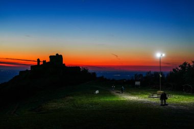 The ruins of Siria medieval fortress from Arad county, in sunset blue hour light, Romania, Europe clipart