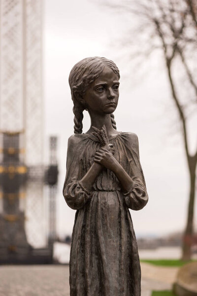 Kyiv, Ukraine - April 13, 2023: Hungry Little Girls Bronze Monument as a symbol of victims of the Holodomor 1932-1933 in Ukraine. Genocide was organized by the Soviet Union Government.