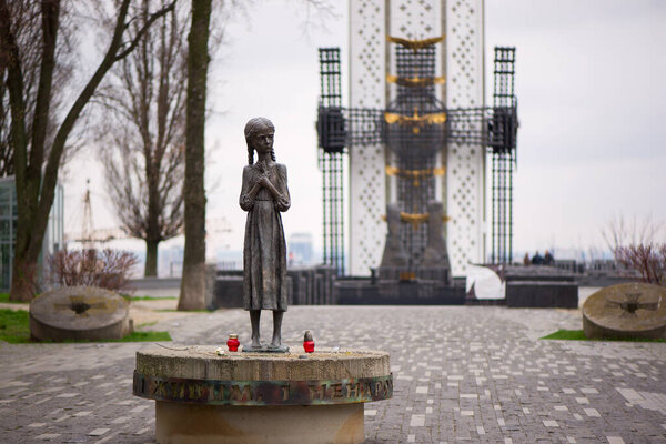 Kyiv, Ukraine - April 13, 2023: Hungry Little Girls Bronze Monument as a symbol of victims of the Holodomor 1932-1933 in Ukraine. Genocide was organized by the Soviet Union Government.