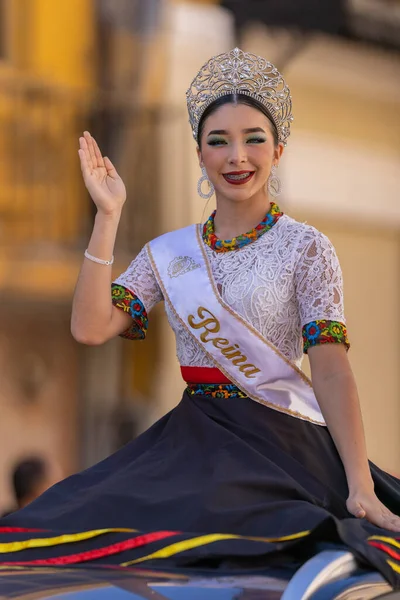 stock image Matamoros, Tamaulipas, Mexico - November 26, 2022: The Desfile del 20 de Noviembre, Beauty queen wearing traditional clothing with a crown, riding on top of a car at the parade