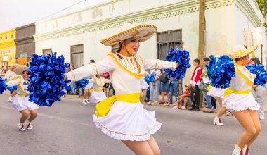 Matamoros, Tamaulipas, Meksika - 25 Şubat 2023: Fiestas Mexicanas Parade, Matamoros Teknoloji Enstitüsü 'nden ponpon kızlar, geleneksel kıyafetler giyip geçit töreninde dans ediyorlar.