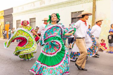 Matamoros, Tamaulipas, Mexico - February 25, 2023: Fiestas Mexicanas Parade, Members of the Folkloric Institute Matamorense, traditional mexican dance group, performing at the parade clipart