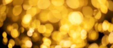 Christmas golden lights Background. Abstract twinkled bright bokeh defocused light