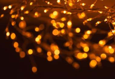 Christmas golden lights Background. Abstract twinkled bright bokeh defocused light