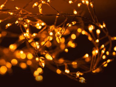 Christmas golden lights Background. Abstract twinkled bright bokeh defocused light