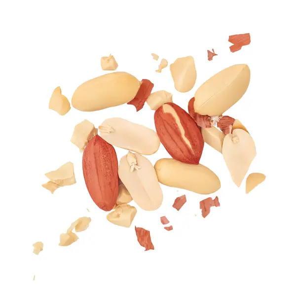 stock image Peanuts and crushed pods levitate in air on white background. Isolated Falling broken  peanuts. Peanut explosion