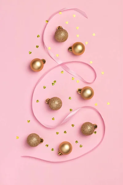 stock image Christmas card with golden glitter balls, confetti in the form of heart and satin ribbon on pink background