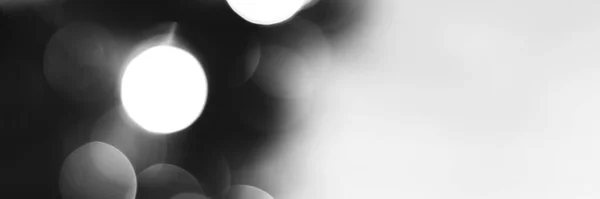 Blurred lights black and white background, banner texture. Abstract bokeh with soft light header. Wide screen wallpaper. Panoramic web banner with copy space for design