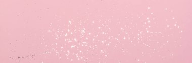 Sparkling silver glitter on pink background banner texture. Abstract holiday blurred lights header. Wide screen wallpaper. Panoramic web banner with copy space for design