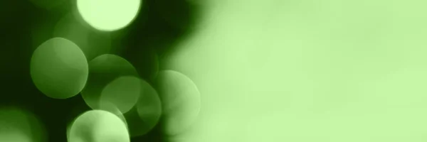 Blurred lights, green background, banner texture. Abstract bokeh with soft light header. Wide screen wallpaper. Panoramic web banner with copy space for design