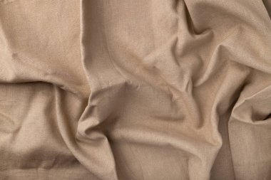 Doğal keten kumaş dokusu. Flaxen tekstil arka planı, üst görünüm. Pürüzlü buruşuk çuval bezi