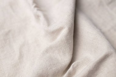 Doğal keten kumaş dokusu. Buruşuk buruşuk çuval bezi. Seçici odak