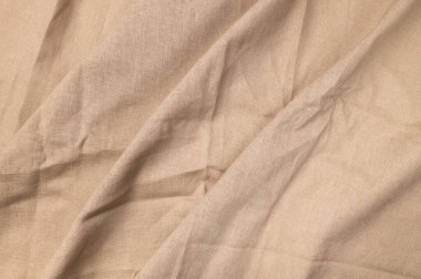 Doğal keten kumaş dokusu. Flaxen tekstil arka planı, üst görünüm. Pürüzlü buruşuk çuval bezi