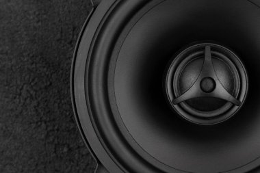 Stylish car audio acoustic round speaker on dark black background, top view. Automobile music, subwoofer, loudspeaker clipart