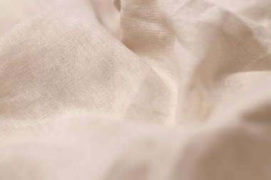 Doğal keten kumaş dokusu. Buruşuk buruşuk çuval bezi. Seçici odak