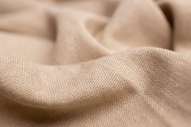 Doğal keten kumaş dokusu. Buruşuk buruşuk çuval bezi. Seçici odak