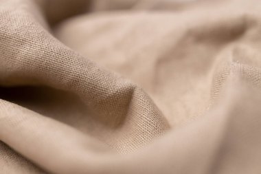 Doğal keten kumaş dokusu. Buruşuk buruşuk çuval bezi. Seçici odak