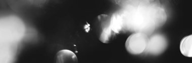 Blurred lights black and white background, banner texture. Abstract bokeh with soft light header. Wide screen wallpaper. Panoramic web banner with copy space for design
