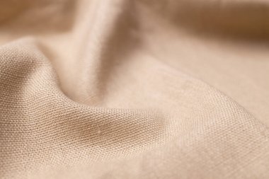 Doğal keten kumaş dokusu. Buruşuk buruşuk çuval bezi. Seçici odak