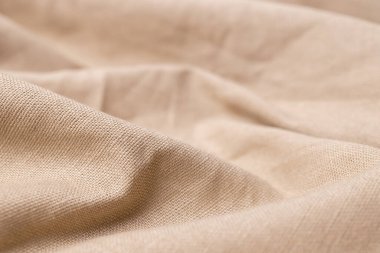 Doğal keten kumaş dokusu. Buruşuk buruşuk çuval bezi. Seçici odak