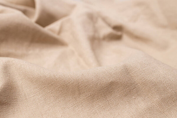 Естественная текстура льняной ткани. Грубый скомканный задний план. Селективный фокус
