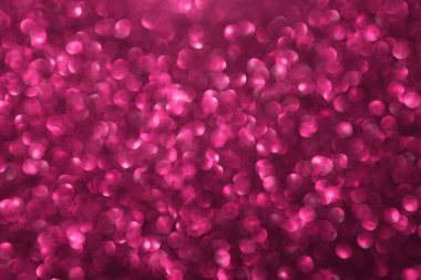 Pembe ışıltılı arka plan, sönmüş parlak ışıklar, soyut parlak doku. Tatil ışıkları.