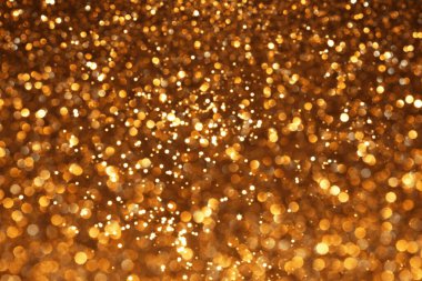 Altın parıltılı şenlik arkaplanı, soyut odaklanmış doku. Tatil ışıkları