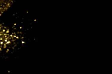 Siyah arka planda altın bulanık bokeh ışıkları. Kutlamak için ışıldayan yıldızlar. Tasarımınız için üstüste