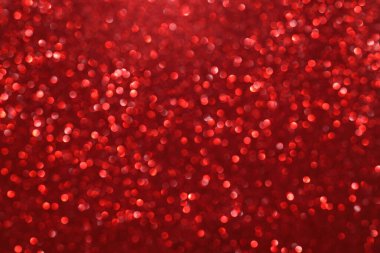 Kırmızı parıltılı arka plan, parlak ışık, soyut odaklanmış doku. Tatil ışıkları.