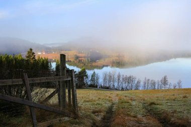 Kasım ayında Norveç 'in Trondheim kentindeki Jonsvatnet Gölü' nde sisli gün batımı