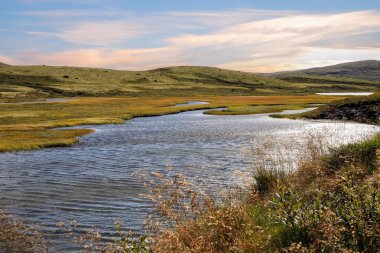 The river Orkla source out of the lake Orkel, Oppdal county , Norway clipart