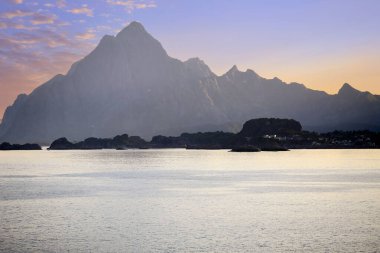 Sunset at the Lofoten islands, mountains near the town Svolvaer. The picture was taken from cruise ship Hurtigruten. clipart