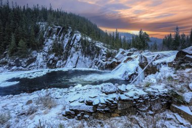 Snowy waterfall Eidfossen located at the river Gaula in Troendelag county, Norway clipart