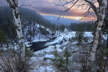 Snowy waterfall Eidfossen located at the river Gaula in Troendelag county, Norway clipart