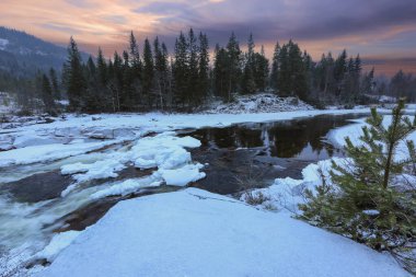 Snowy winter river Gaula located in Troendelag county, Norway clipart