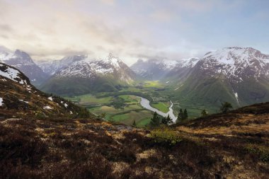 Aerial view of the  area Romsdalen and Isterdalen  located at the mouth of the river Rauma and at the shores of the Romsdalsfjord. clipart