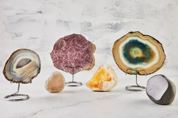 Collection of semi-precious stones of different colors and patterns on white background.