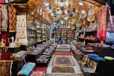Jerusalem, Israel - November 15, 2022: Arab Bazaar in the Old City of Jerusalem. Shop selling carpets and dishes.