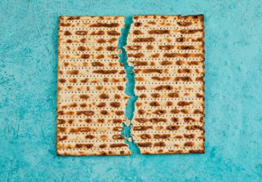 Pesach celebration concept - Jewish holiday Pesach. Matzah square broken in half. View from above. Flat lay. Close up. clipart