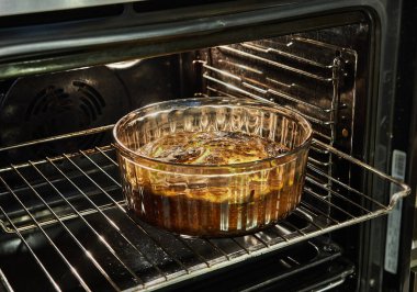 Cauliflower souffle in a transparent bowl in the oven after baking.