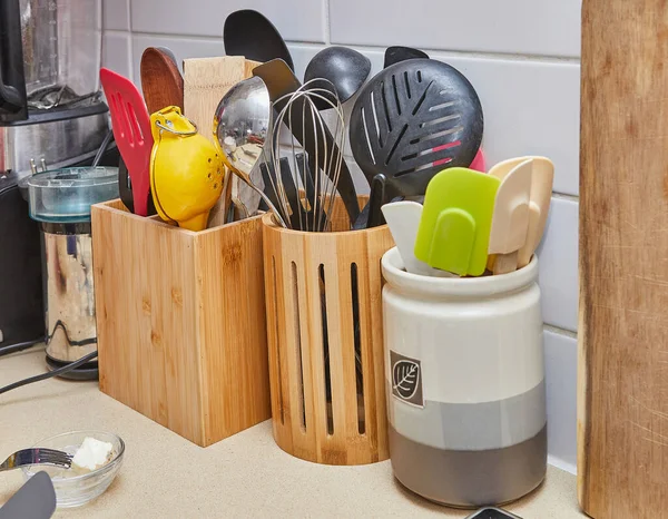 Home kitchen with wooden and ceramic stands for storing various kitchen items.