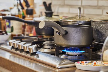 Değişik tencere ve kapaklarla dolu canlı mutfak ortamları, yanan alevler, lezzetli yemekler evde hazırlanırken, rahat ve davetkar bir atmosfer yaratıyor..