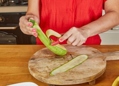 Whole garlic cloves are added to hot oil in a frying pan, beginning the process of infusing flavors for cooking. clipart