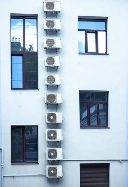 Vertical Row Air Condicioners White Tall Building Asymmetrical Windows Blue — Stock Photo, Image