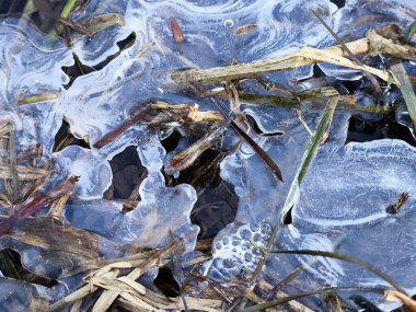 Donmuş su yüzeyindeki kırık buzun yakın plan görüntüsü hassas kış şablonları sergiliyor..