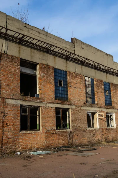 ruins of a very heavily polluted industrial plant, broken windows, dirty walls. atmospheric Building of the former chemical plant, Ukraine. Industrial background, texture.