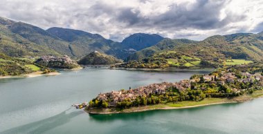 Panoramic sight of Lake Turano, with the beautiful villages of Colle di Tora and Castel di Tora, in the Province of Rieti. Lazio, Italy. clipart