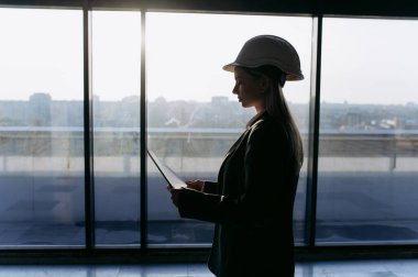 Bir iş kadınının portresi, inşaat alanında çalışan bir mühendis. Planı olan bir kadın mimar..