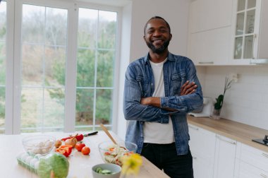 Afro-Amerikalı bir adam sebze salatası hazırlıyor, sağlıklı bir yemek..